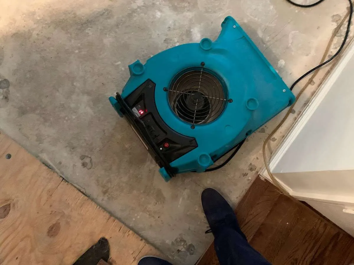 Air mover drying subfloor during Commercial Water Damage Restoration in Toms River